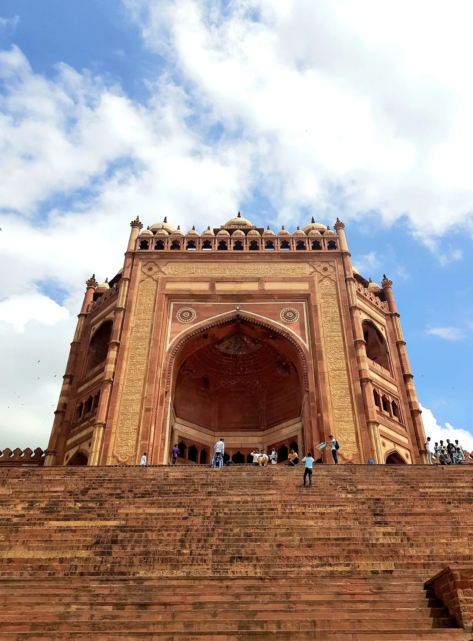 A very tall sandstone gateway above a flight of steps