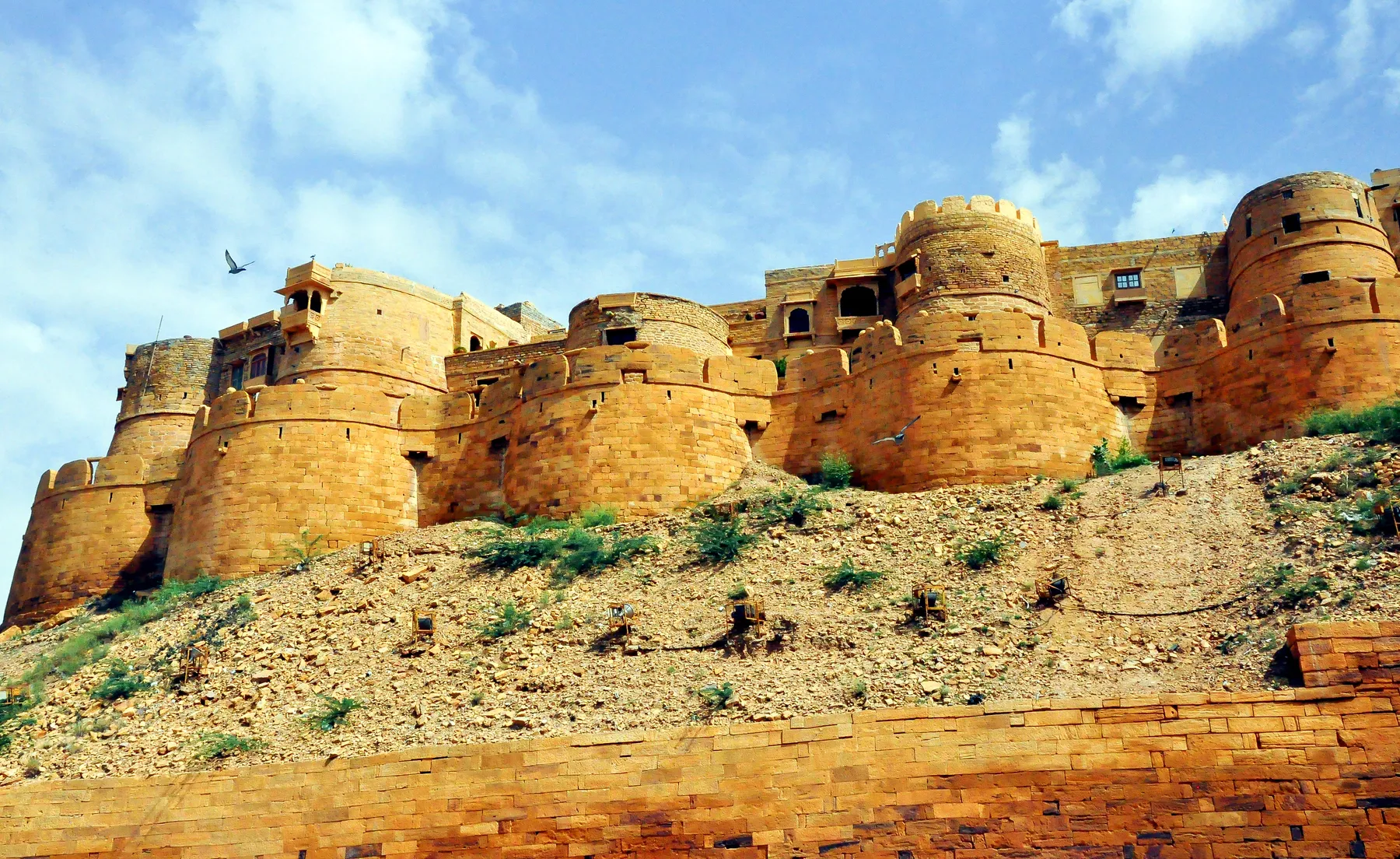 The round sandstone bastions of Jaisalmer fort against a clear sky