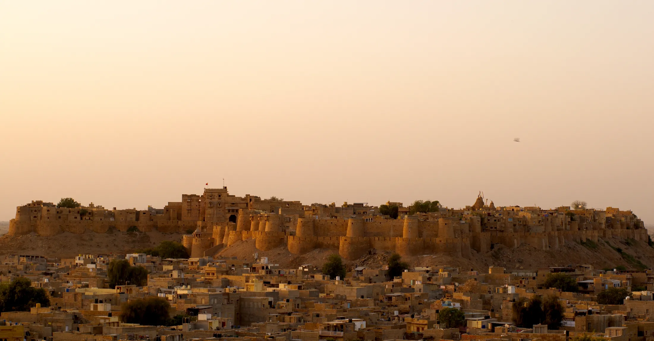 The round sandstone bastions of Jaisalmer fort against a clear sky