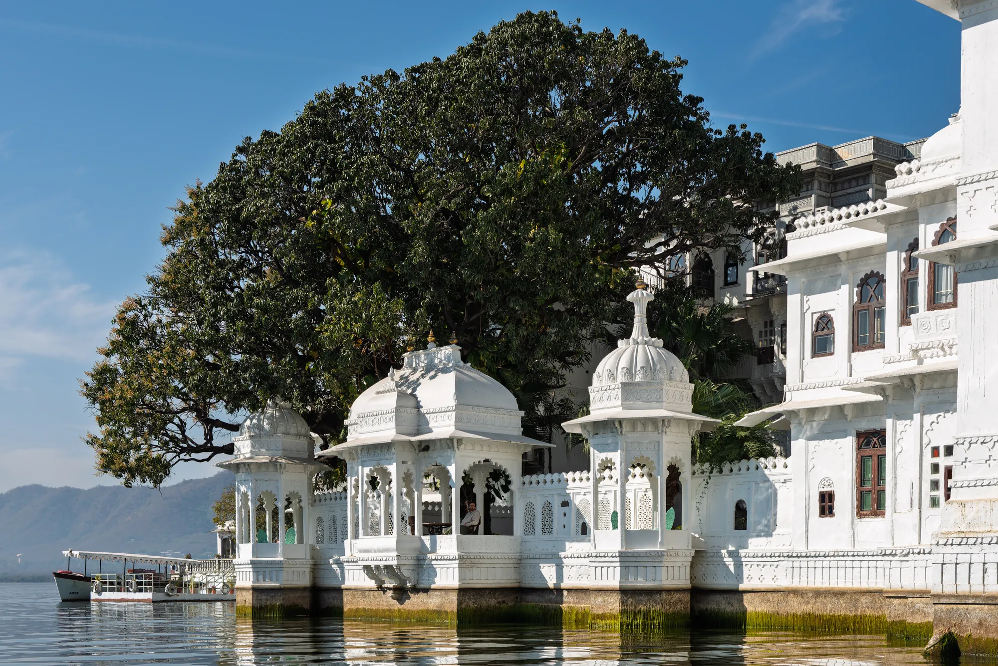 A white marble palace occupying an island on a still lake